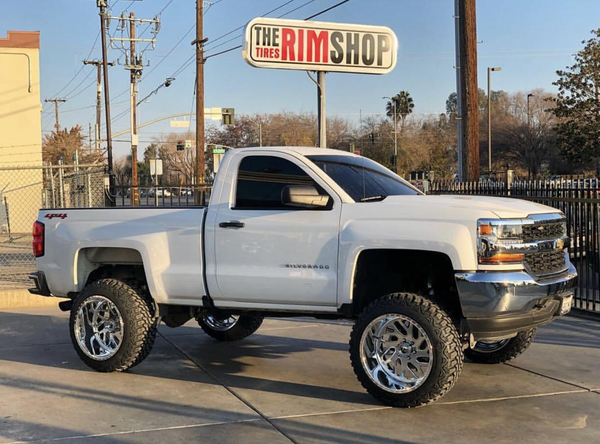 White Silverado truck with new wheels installed