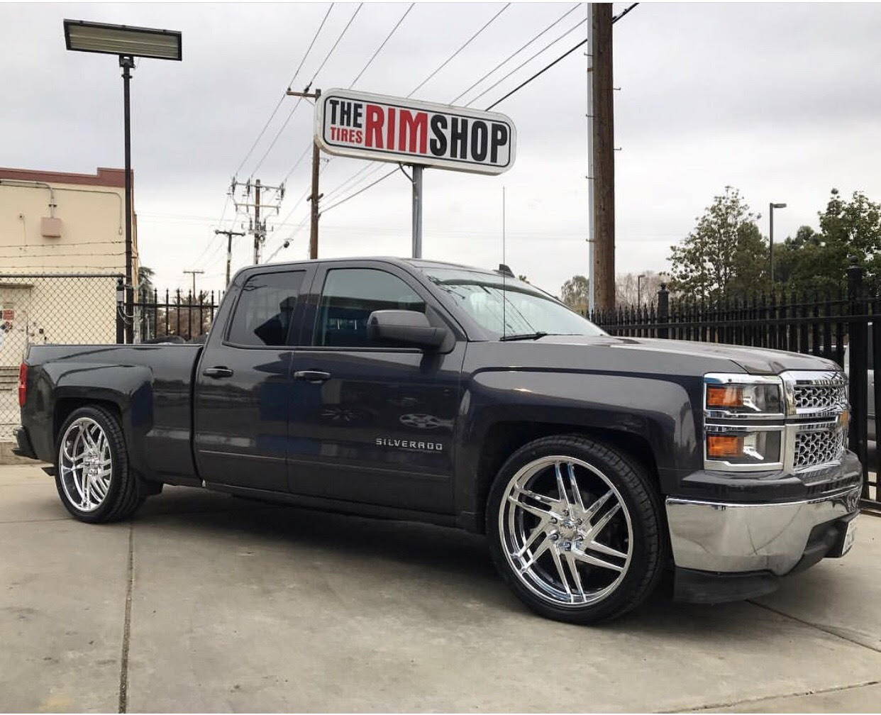 Black Silverado truck with custom wheels