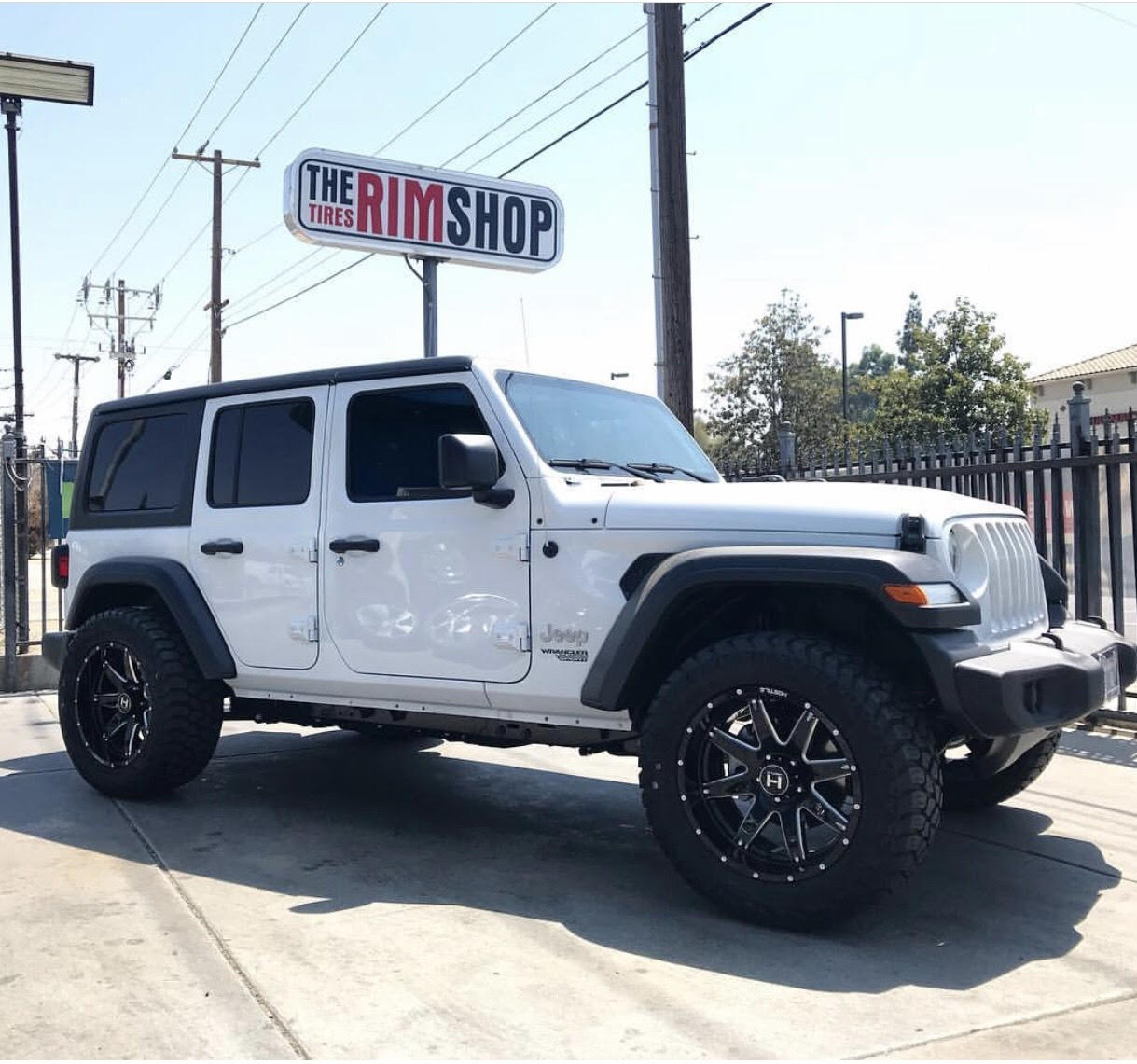 White Jeep Wrangler with custom wheels installed