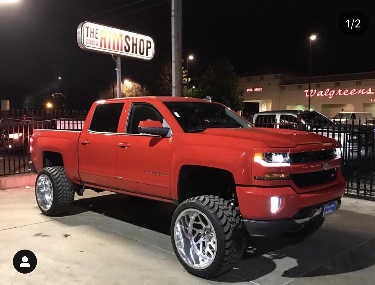 Red Chevy Silverado lifted with new wheels